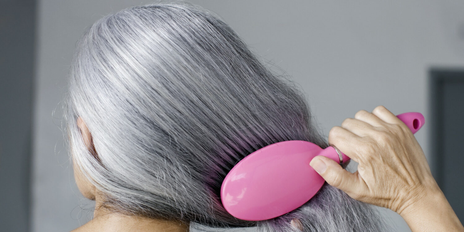 Grey hair with pink brush